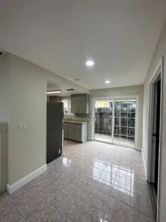 an empty room with wooden floor and fireplace