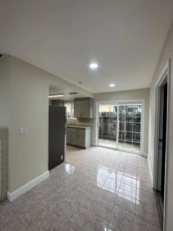 an empty room with wooden floor and fireplace