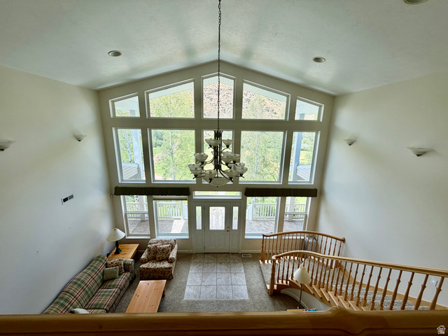 1133 Paris Canyon Road Paris, ID 83261 - Photo 7 of 75 Two-story entry featuring a soaring vaulted ceiling, extensive window array, and a tiered chandelier