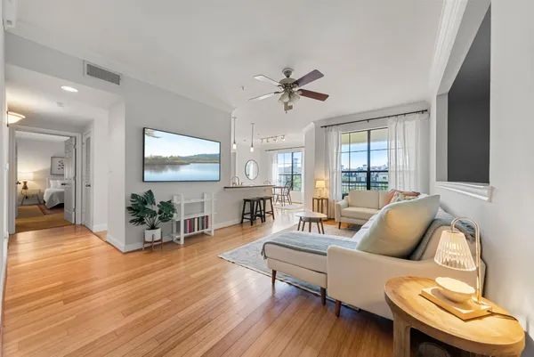 a living room with furniture and a wooden floor