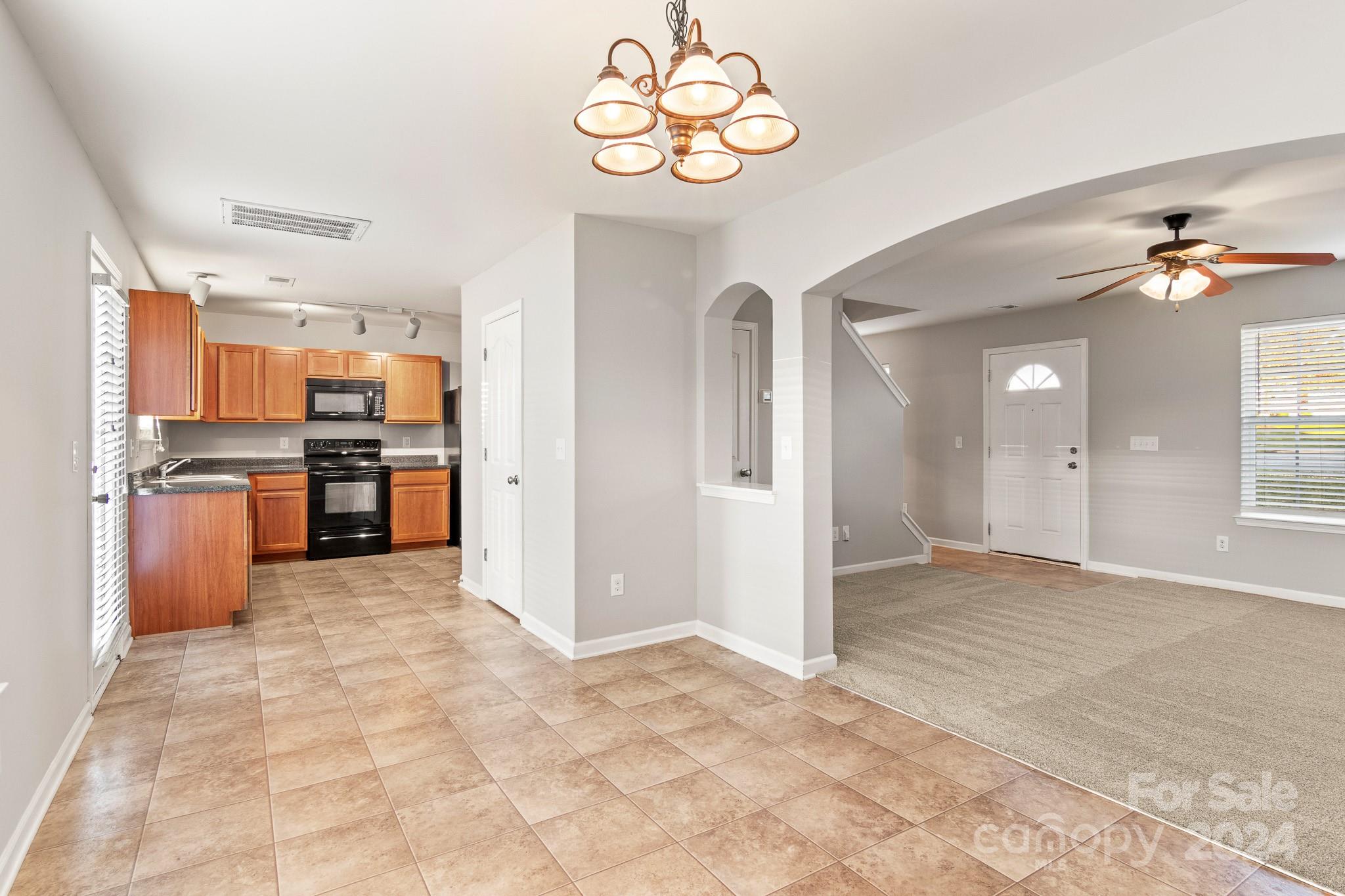 4071 Clover Road Northwest Concord, NC 28027 - Photo 13 of 43 a view of kitchen with stainless steel appliances granite countertop cabinets and chandelier
