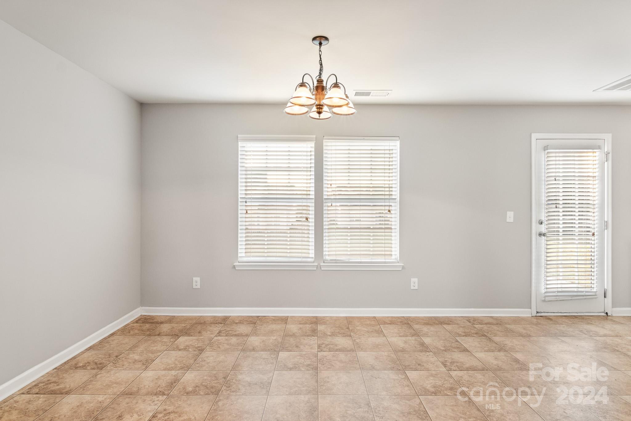 4071 Clover Road Northwest Concord, NC 28027 - Photo 15 of 43 an empty room with chandelier fan and windows