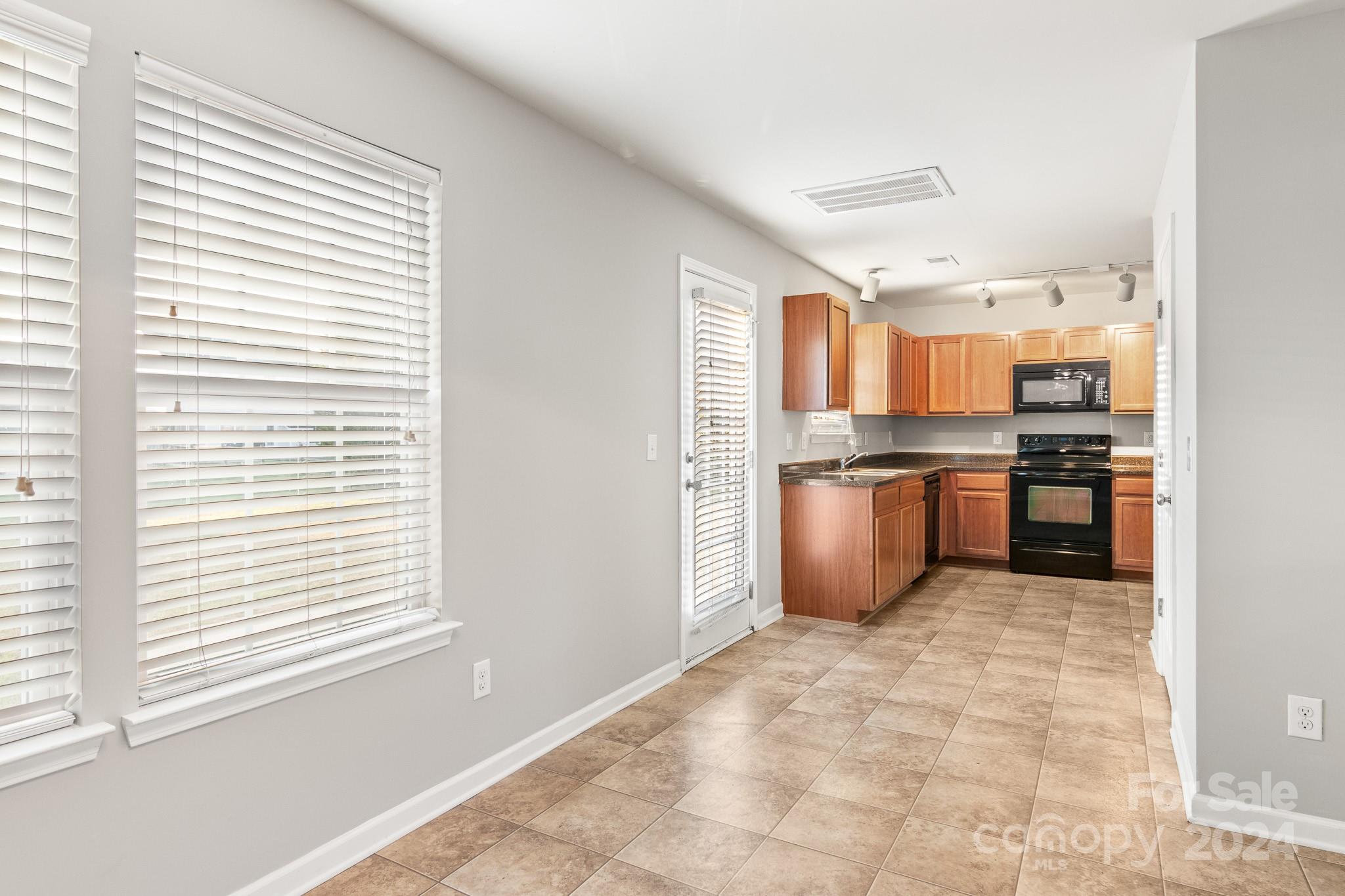 4071 Clover Road Northwest Concord, NC 28027 - Photo 16 of 43 a kitchen with stainless steel appliances granite countertop a refrigerator and a stove top oven