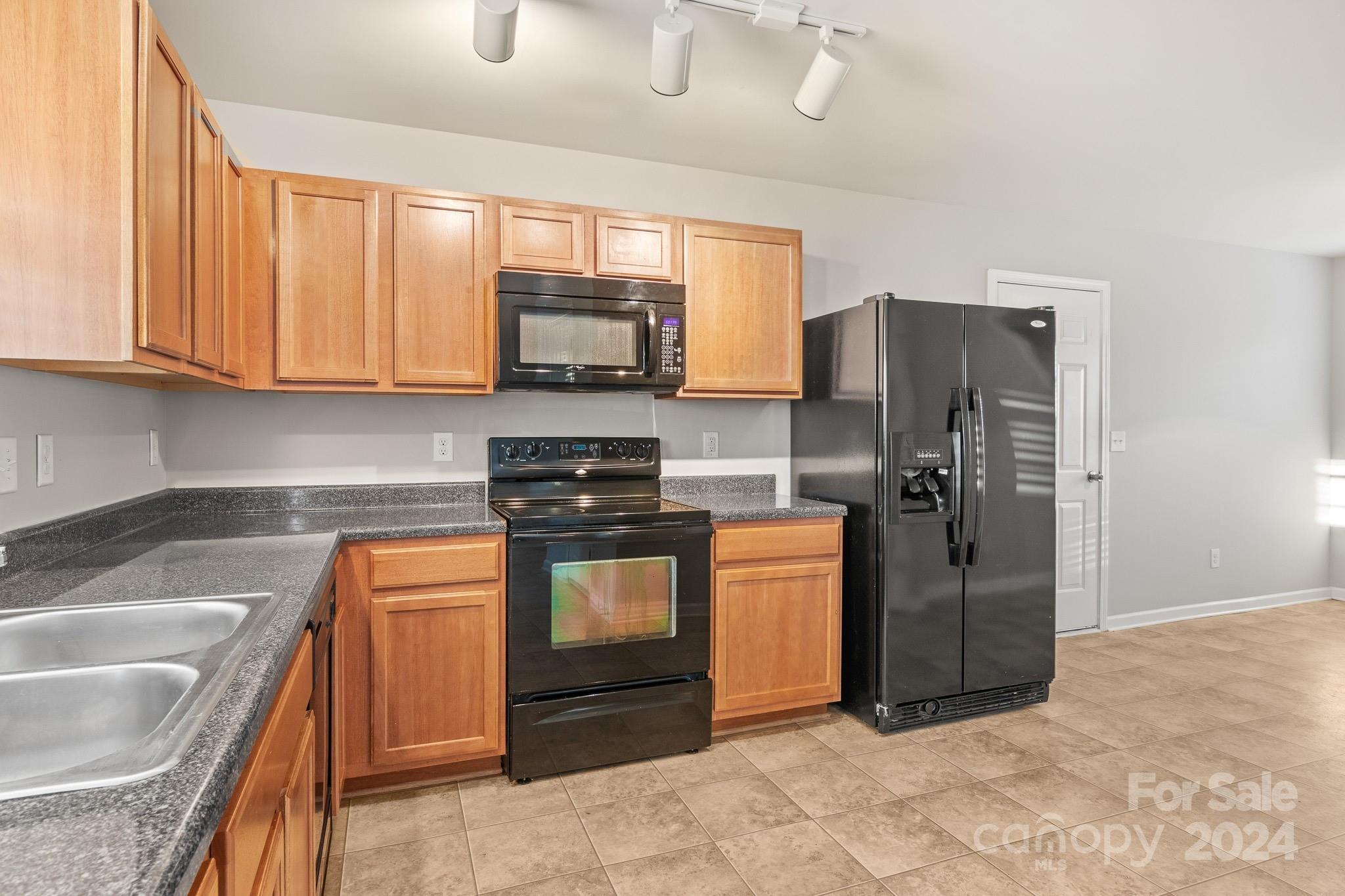 4071 Clover Road Northwest Concord, NC 28027 - Photo 17 of 43 a kitchen with stainless steel appliances granite countertop a refrigerator a stove a sink and dishwasher