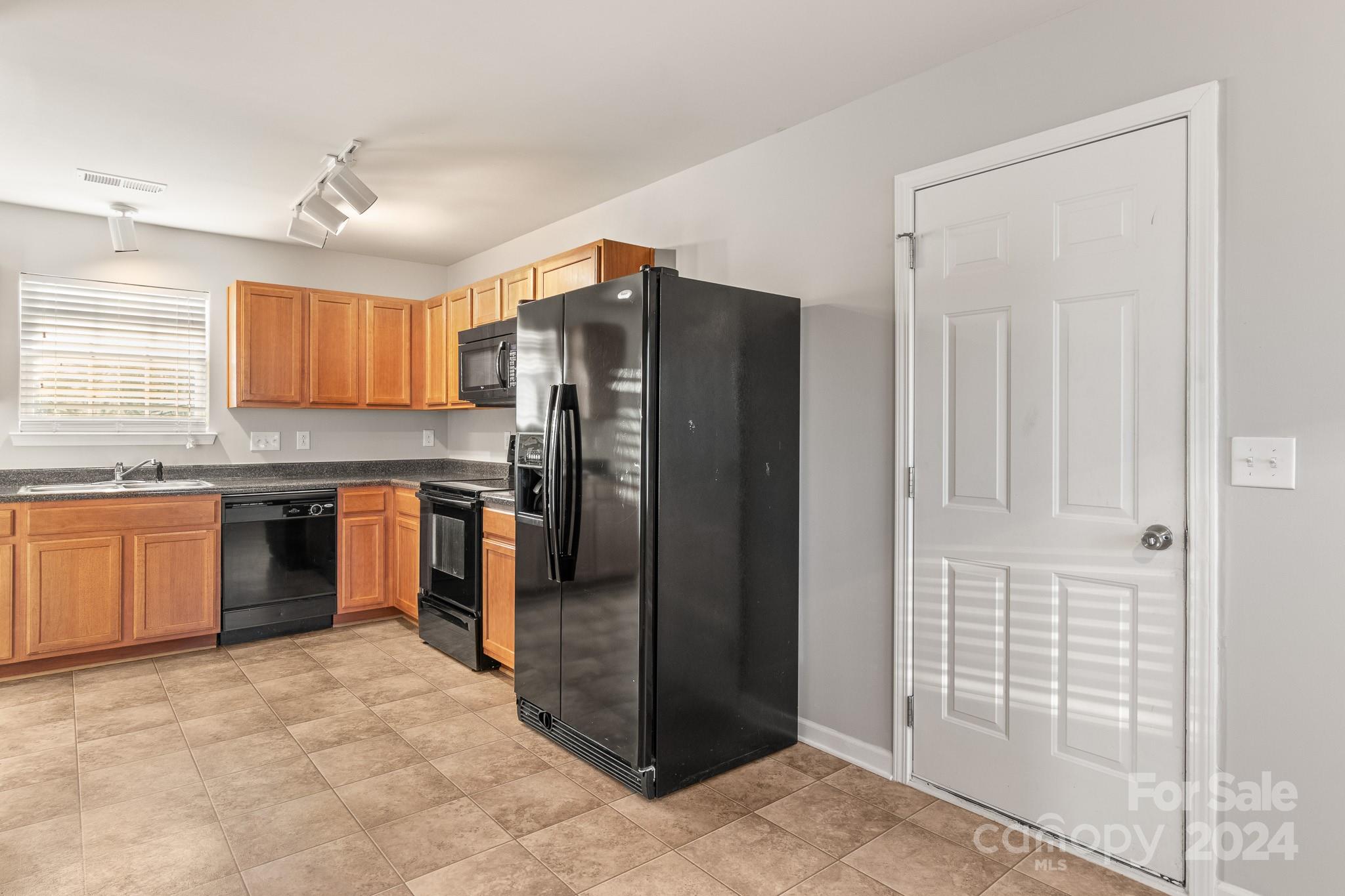 4071 Clover Road Northwest Concord, NC 28027 - Photo 21 of 43 a kitchen with granite countertop a refrigerator and a sink