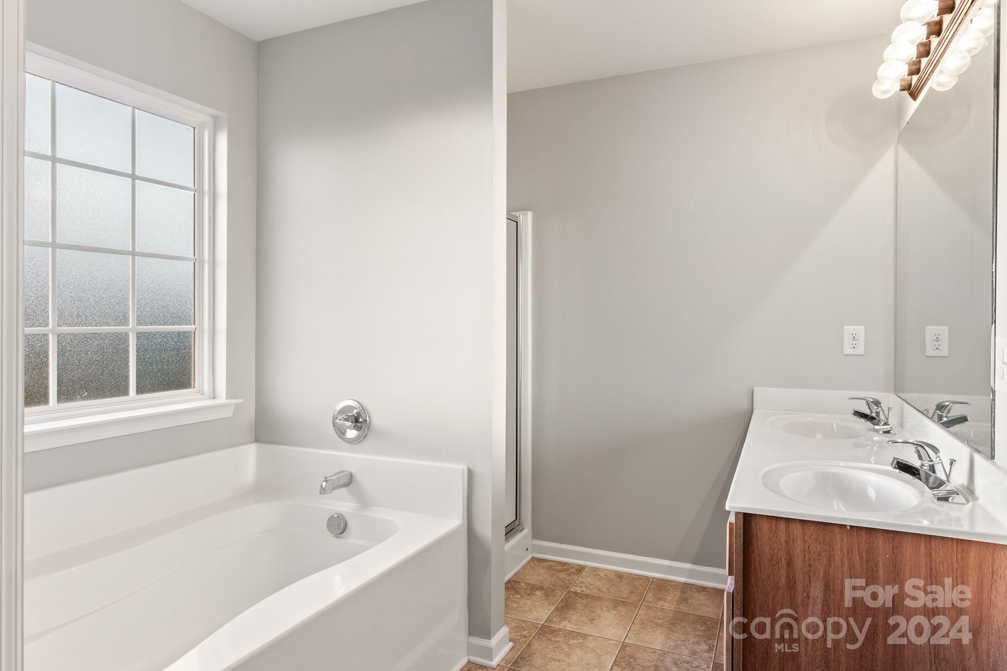 4071 Clover Road Northwest Concord, NC 28027 - Photo 31 of 43 a bathroom with a granite countertop sink and a bathtub