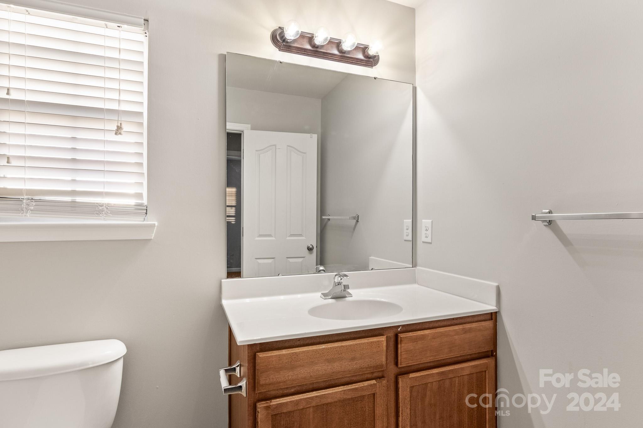 4071 Clover Road Northwest Concord, NC 28027 - Photo 35 of 43 a bathroom with a sink toilet and a mirror