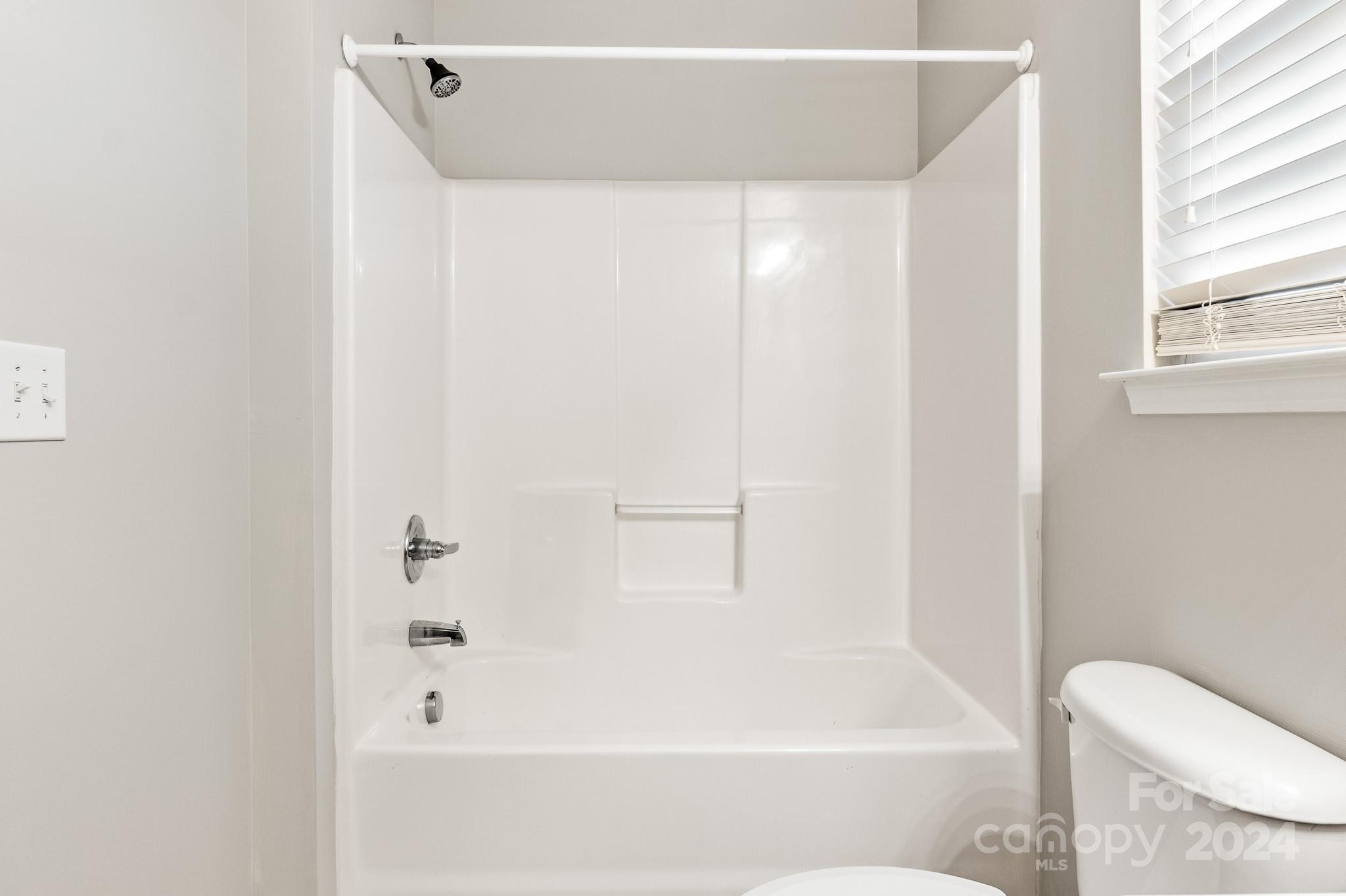 4071 Clover Road Northwest Concord, NC 28027 - Photo 36 of 43 a bathroom with a bathtub and a toilet