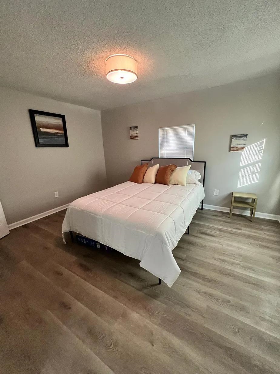 549 South Rowlett Street Collierville, TN 38017 - Photo 9 of 27 a bedroom with a bed and a lamp on dresser