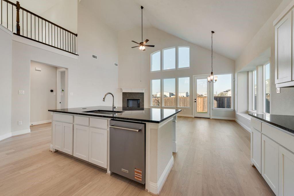 1329 Sundance Lane Justin, TX 76247 - Photo 15 of 37 a kitchen with stainless steel appliances granite countertop a sink a stove and a wooden floors