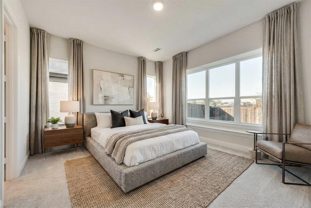 1329 Sundance Lane Justin, TX 76247 - Photo 17 of 37 a bedroom with a bed and a couch next to a window