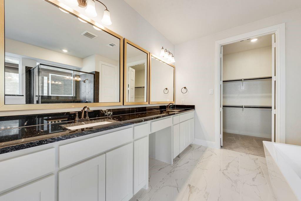 1329 Sundance Lane Justin, TX 76247 - Photo 21 of 37 a bathroom with a sink and a mirror