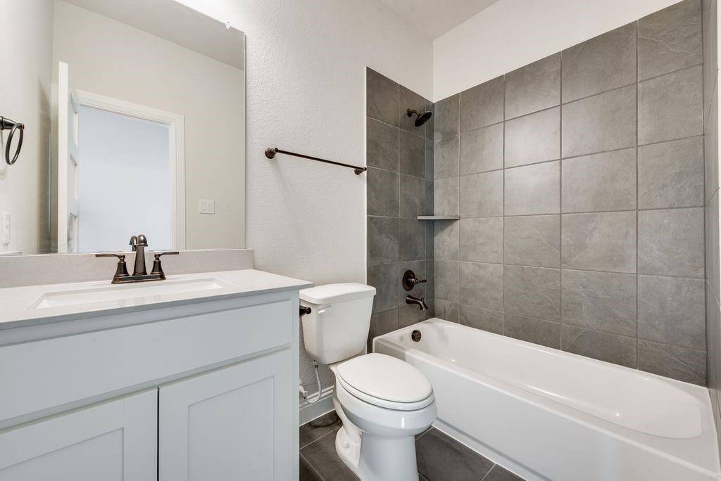 1329 Sundance Lane Justin, TX 76247 - Photo 33 of 37 a bathroom with a sink a toilet and a bathtub