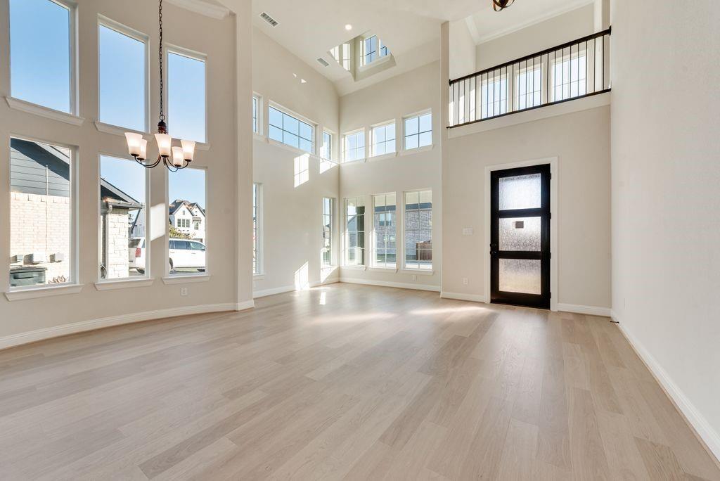 1329 Sundance Lane Justin, TX 76247 - Photo 4 of 37 a view of an empty room with a window and wooden floor