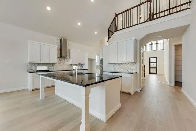 a kitchen with granite countertop a sink and cabinets