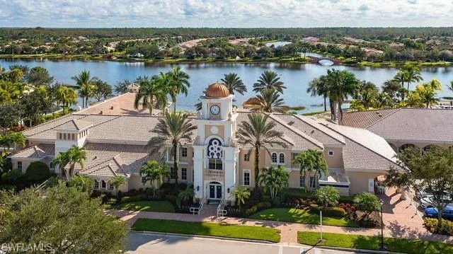 an aerial view of a residential houses with outdoor space and lake view