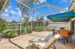 a view of a patio with a table chairs and a yard