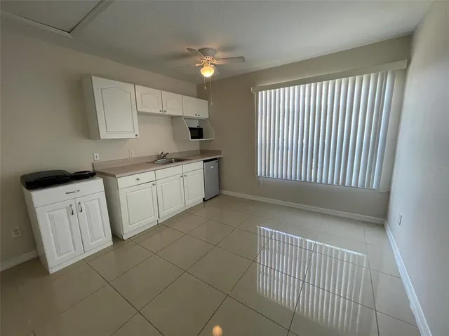 a view of a kitchen with white cabinets