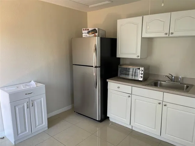 a white refrigerator freezer sitting inside of a kitchen