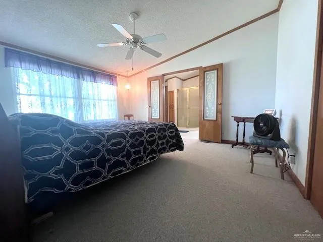 a bed sitting in a bedroom next to a window