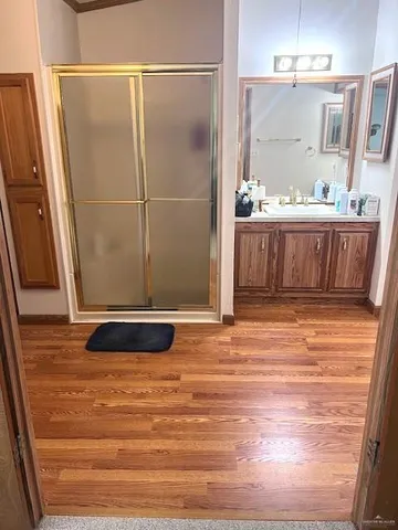 a bathroom with a sink a mirror and shower