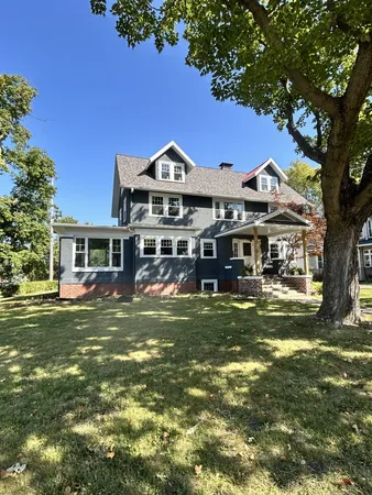 a front view of a house with a garden