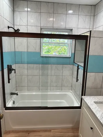a bathroom with a bathtub and shower