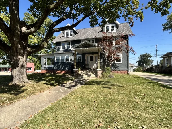 a view of a building with a tree in front of it