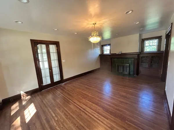 a view of a room with wooden floor and staircase