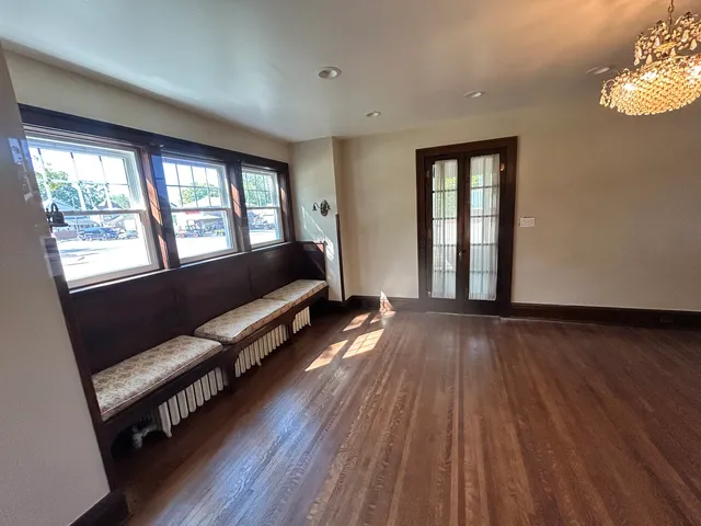 a living room with furniture and a hard wood floor