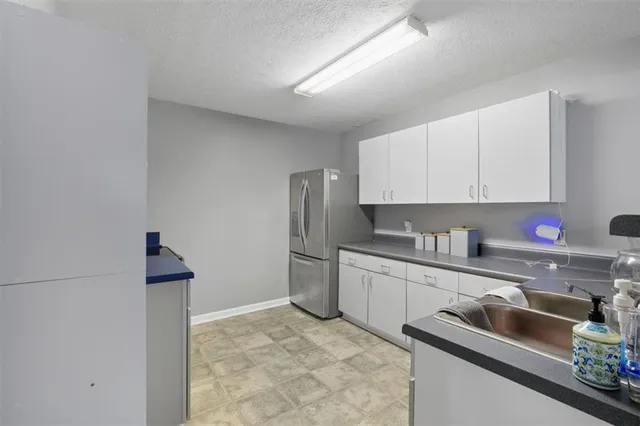 a view of a dining room with furniture and a chandelier