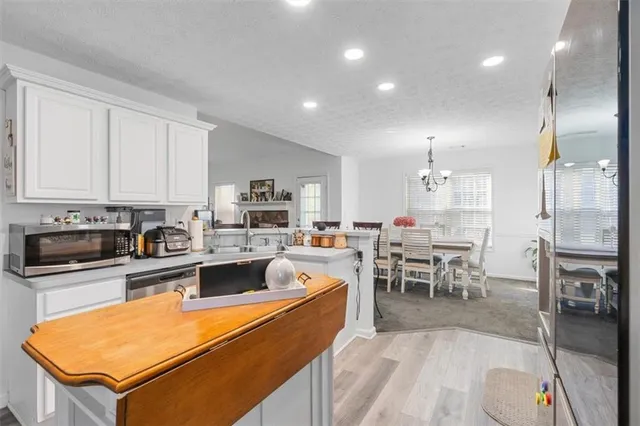 a kitchen with a sink stainless steel appliances and cabinets
