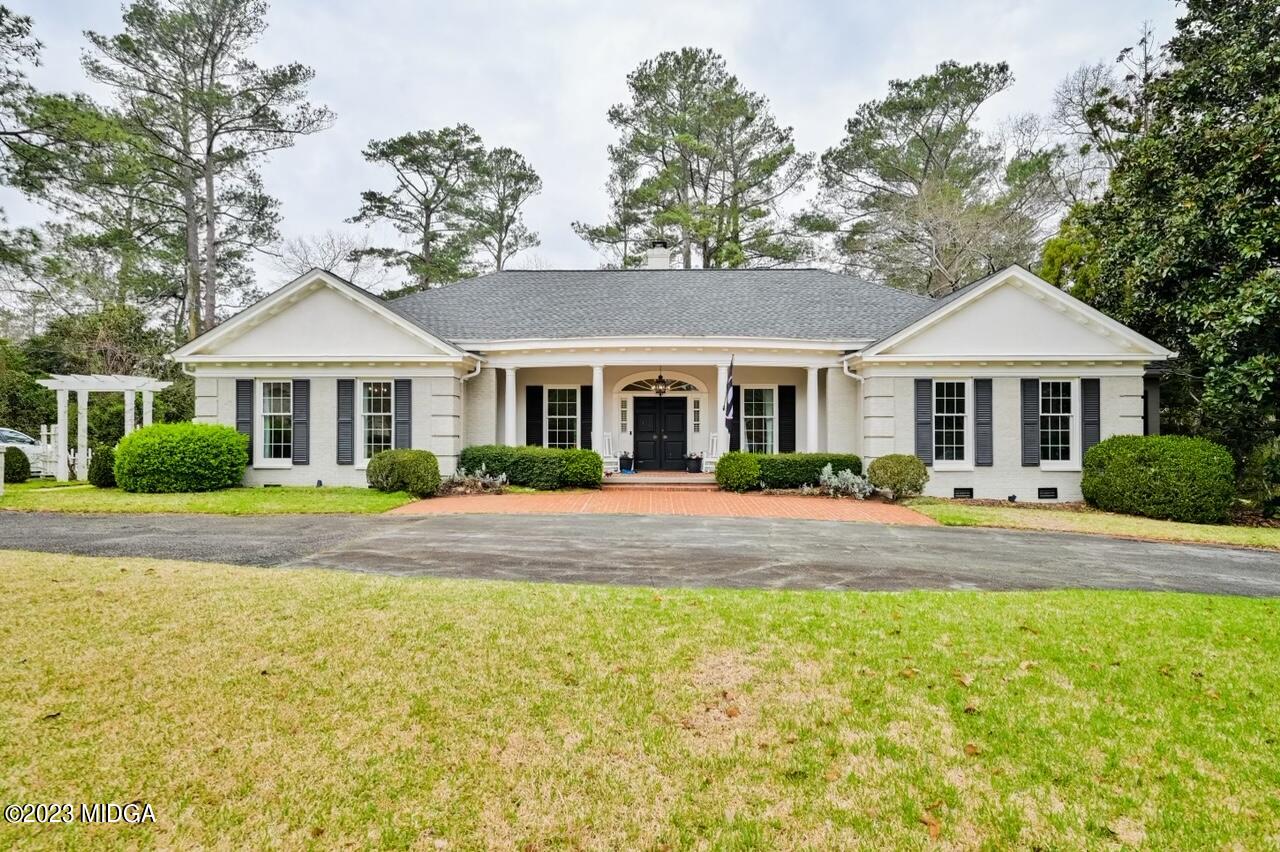 4163 Canyon Road Macon, GA 31210 - Photo 1 of 20 a front view of a house with a yard