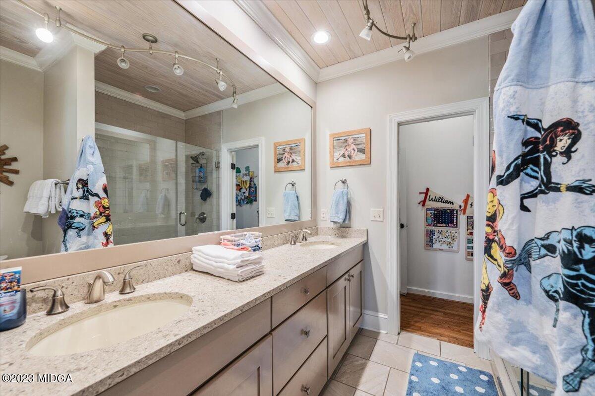4163 Canyon Road Macon, GA 31210 - Photo 13 of 20 a en suite bathroom with double vanity and a mirror