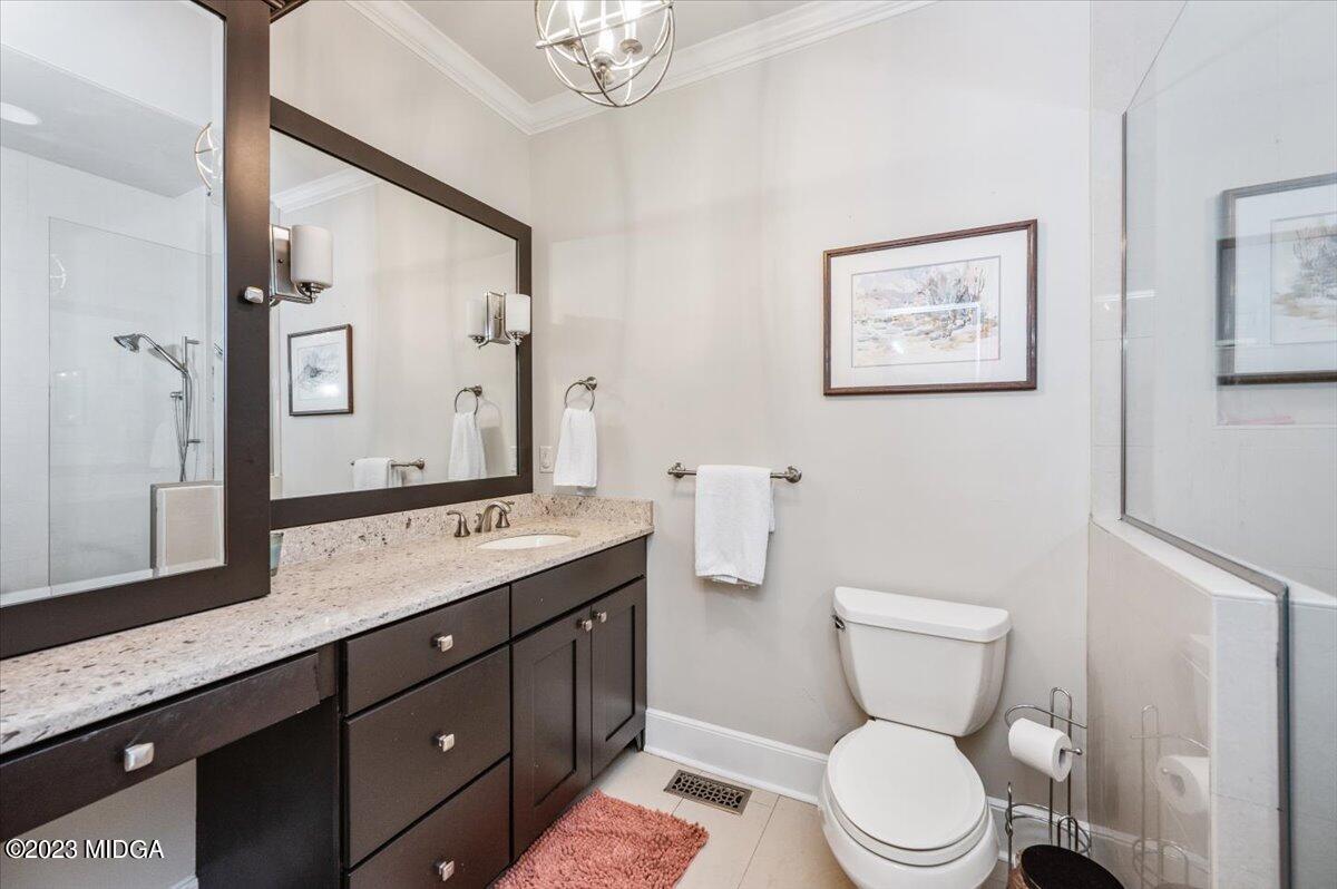 4163 Canyon Road Macon, GA 31210 - Photo 15 of 20 a bathroom with a toilet a sink and mirror