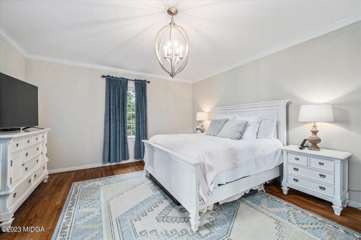 4163 Canyon Road Macon, GA 31210 - Photo 18 of 20 a bedroom with a large bed and a flat tv screen on dresser