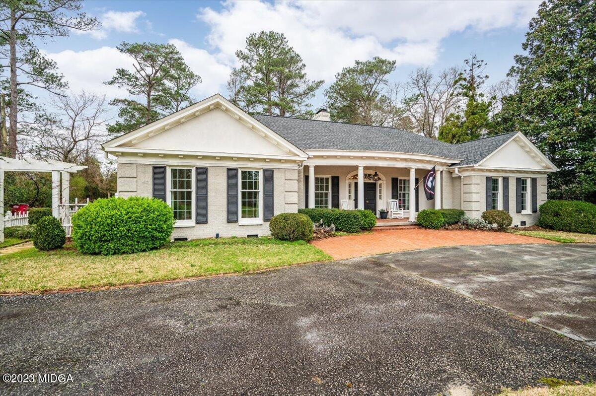 4163 Canyon Road Macon, GA 31210 - Photo 20 of 20 a front view of a house with a yard and garage