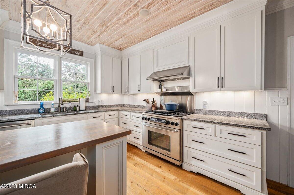 4163 Canyon Road Macon, GA 31210 - Photo 6 of 20 a kitchen with stainless steel appliances white cabinets and a window