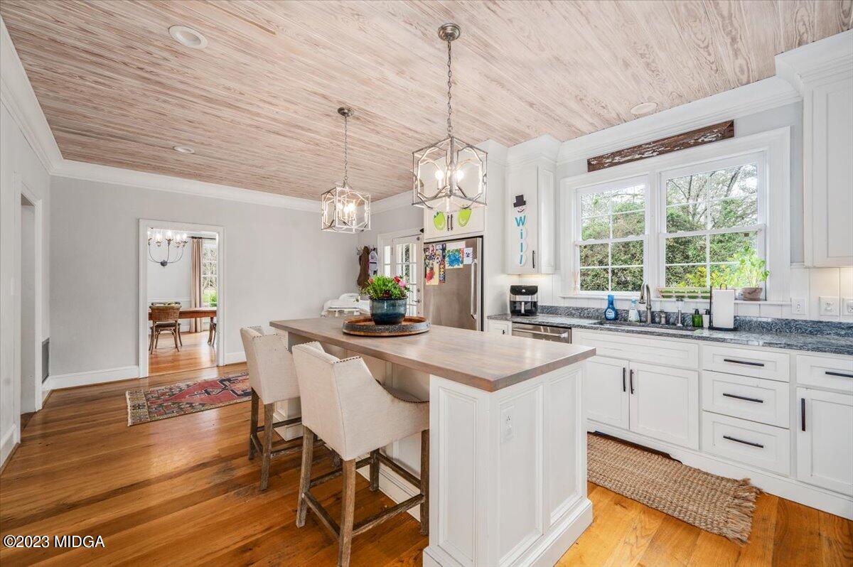 4163 Canyon Road Macon, GA 31210 - Photo 7 of 20 a kitchen with stainless steel appliances granite countertop a table chairs sink and cabinets