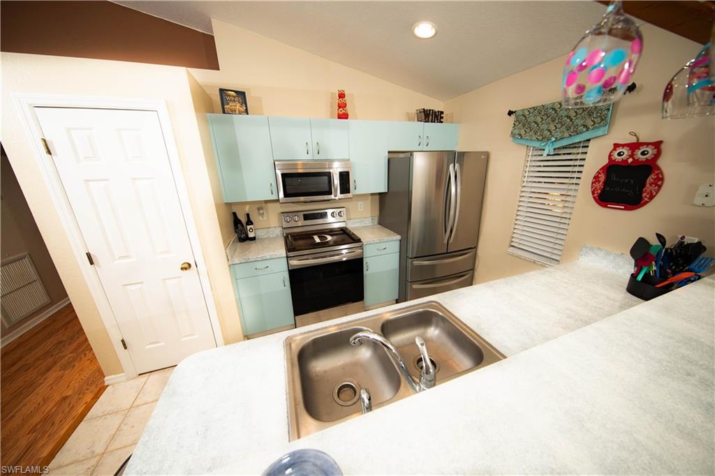 18561 Sunflower Road Fort Myers, FL 33967 - Photo 4 of 10 a kitchen with a sink appliances and cabinets