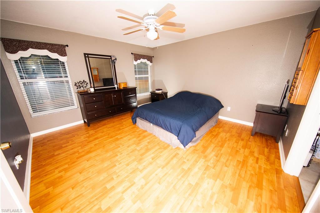 18561 Sunflower Road Fort Myers, FL 33967 - Photo 5 of 10 a living room with a bed furniture and a flat screen tv