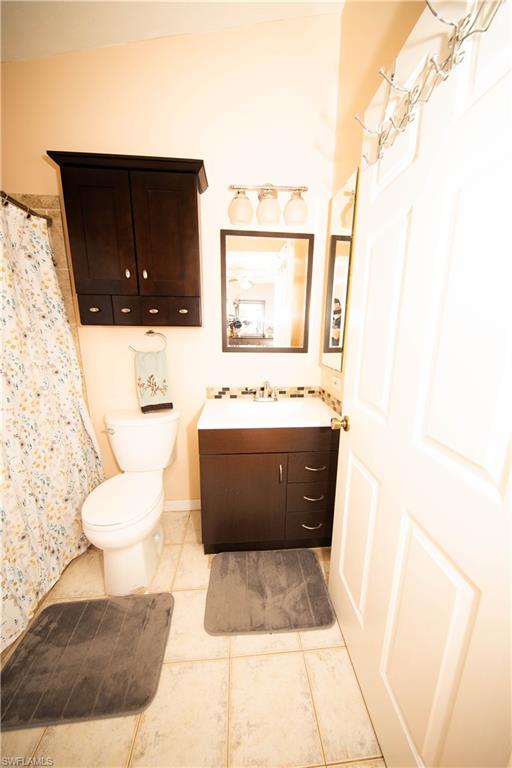 18561 Sunflower Road Fort Myers, FL 33967 - Photo 6 of 10 a bathroom with a sink a toilet and a mirror