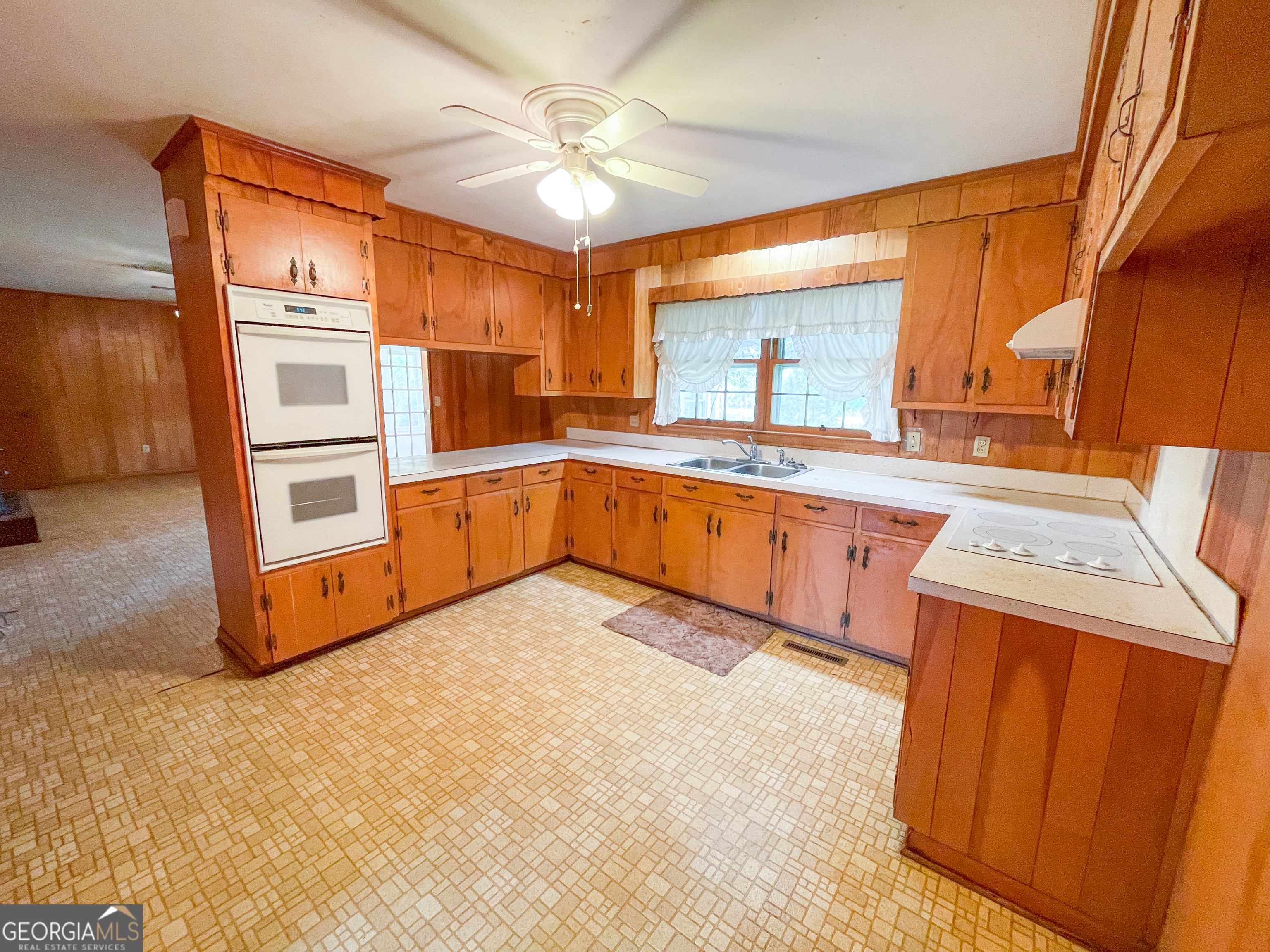 7517 Blacks Bluff Road Southwest Cave Spring, GA 30124 - Photo 20 of 57 a kitchen with a stove a sink and a refrigerator