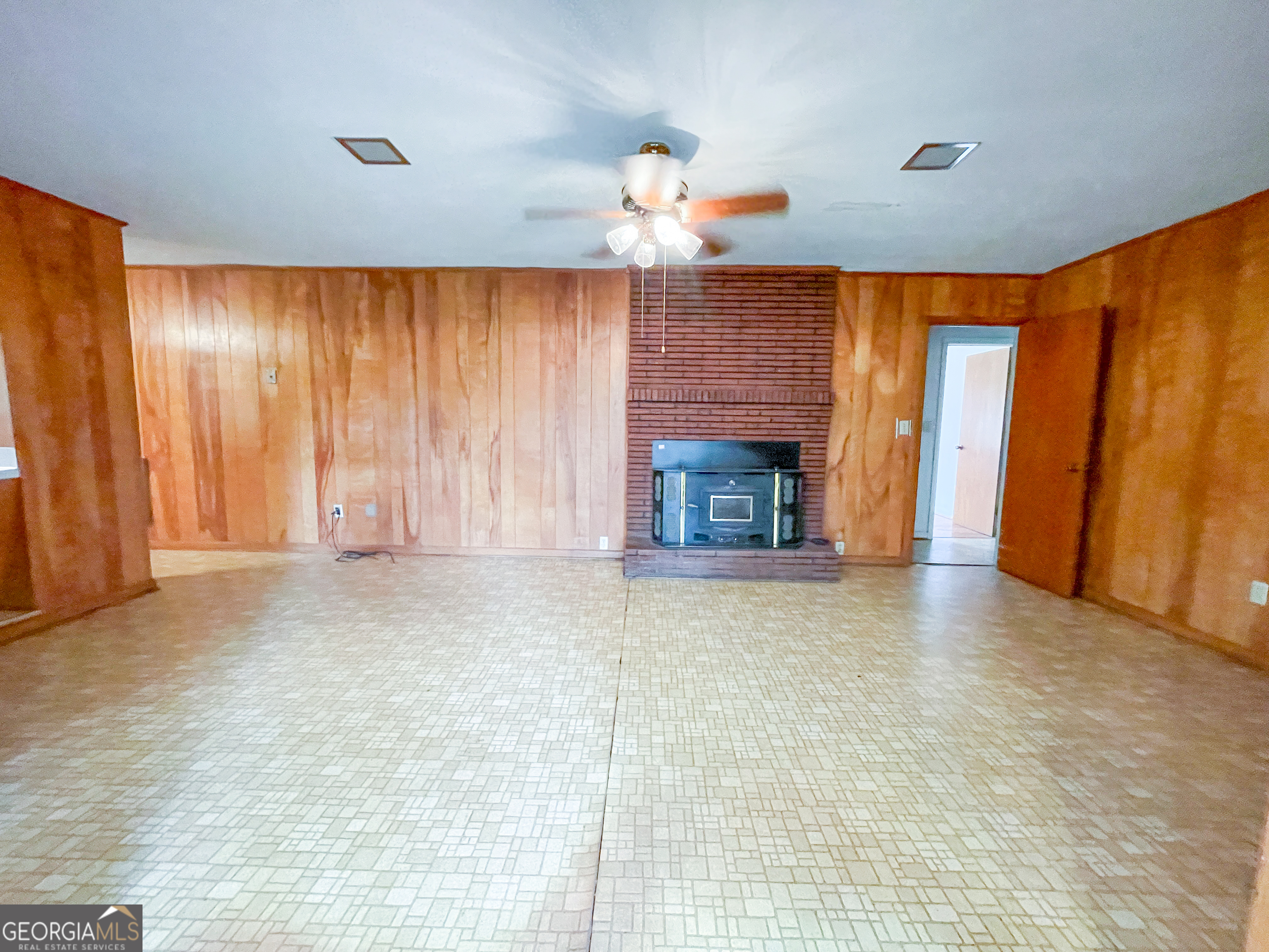7517 Blacks Bluff Road Southwest Cave Spring, GA 30124 - Photo 26 of 57 a view of empty room with a fireplace and fan