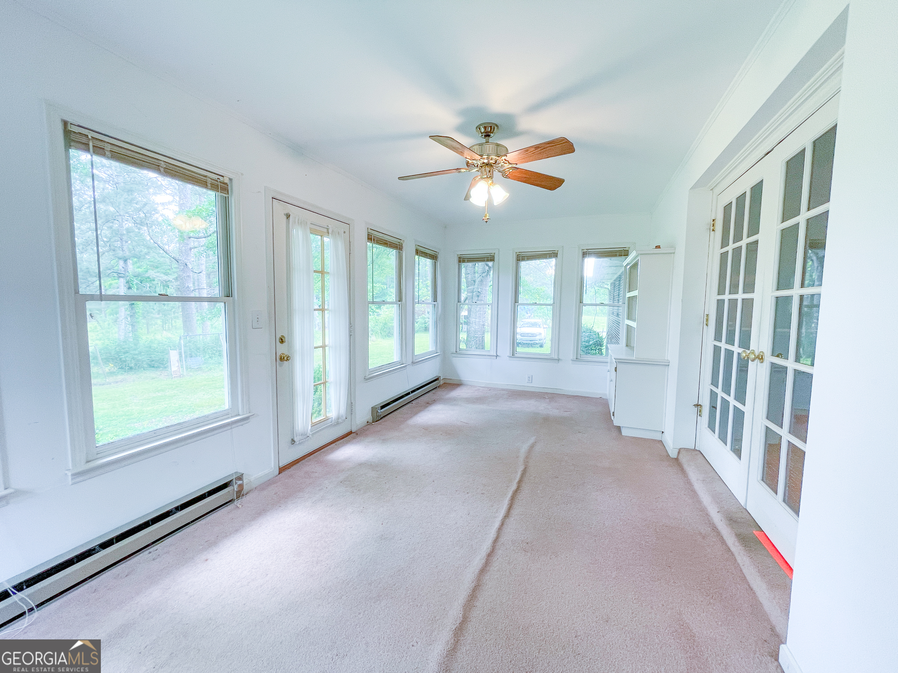 7517 Blacks Bluff Road Southwest Cave Spring, GA 30124 - Photo 29 of 57 an empty room with windows and ceiling fan
