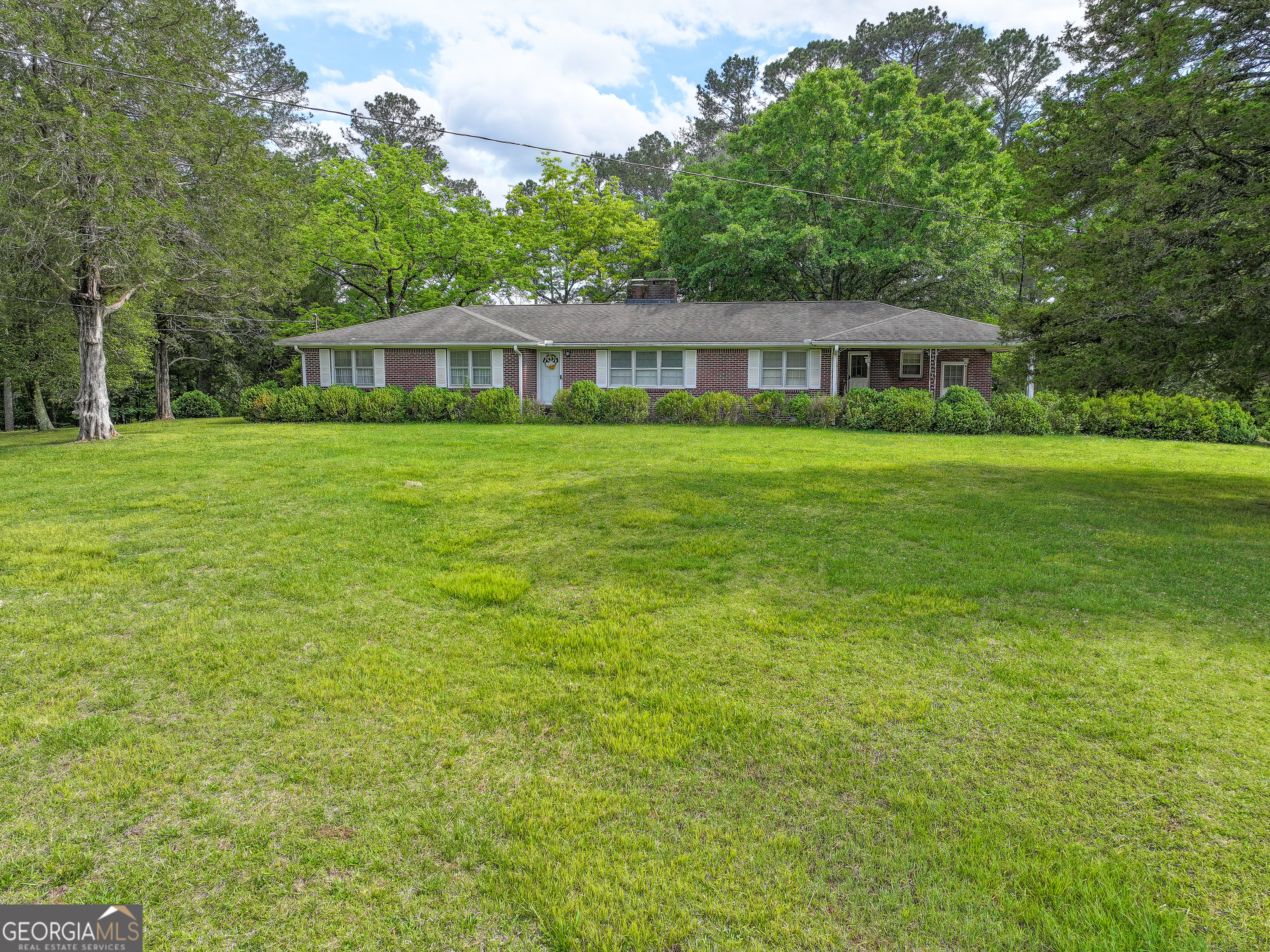 7517 Blacks Bluff Road Southwest Cave Spring, GA 30124 - Photo 3 of 57 a front view of a house with a garden