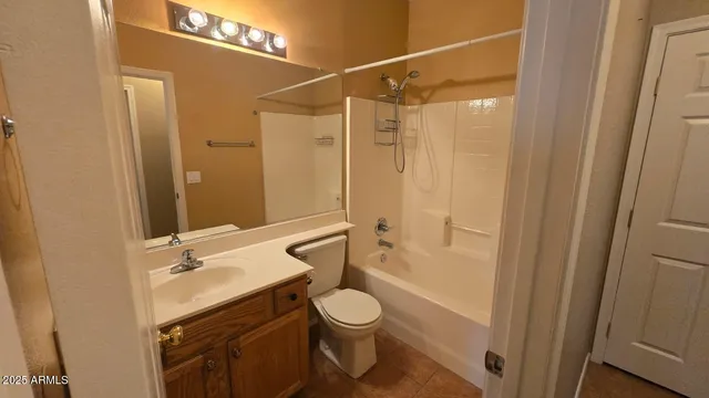 a bathroom with a granite countertop sink toilet a mirror and shower