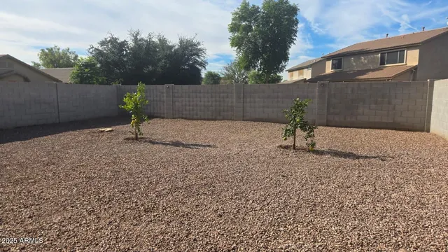 a backyard of a house with plants and trees