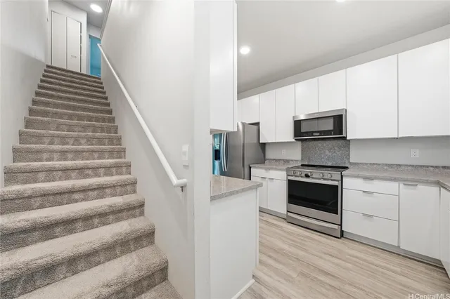 a kitchen with stainless steel appliances and white cabinets