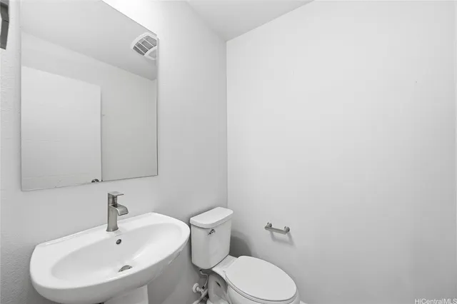 a bathroom with a sink a toilet and mirror